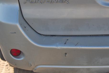 Car bumper chewed by lions, Kalahari